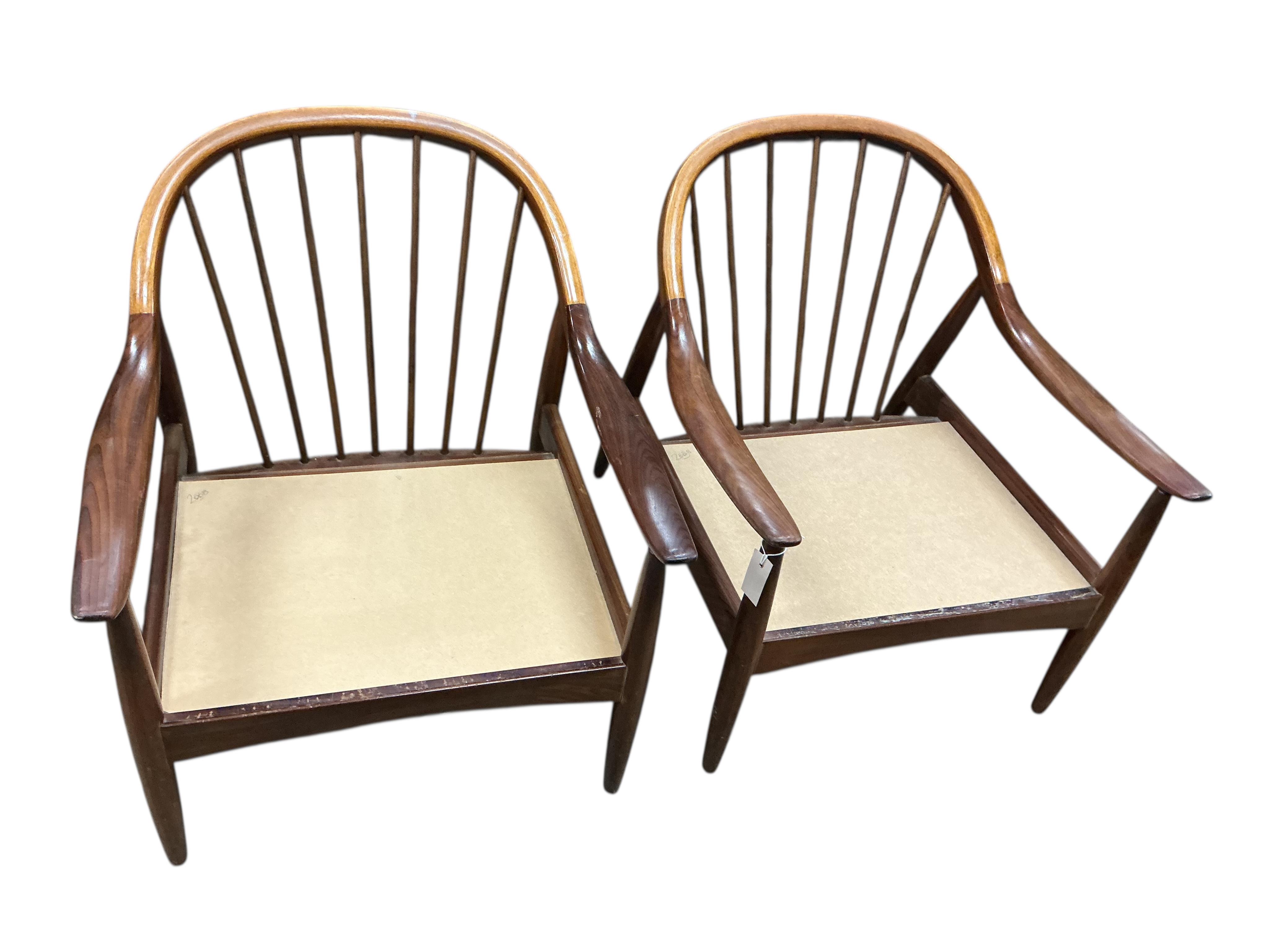 Greaves and Thomas: A pair of mid century teak stick back armchairs, width 62cm, depth 70cm, height 70cm